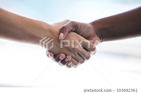 Coming together to make things happen. Cropped shot of two unrecognizable businesswomen shaking hands while standing in an office. 103692361