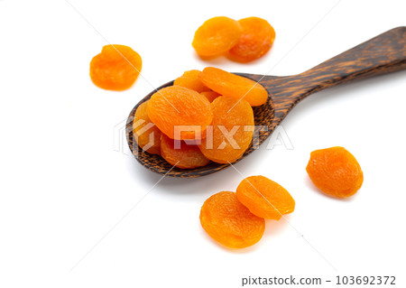 Dried apricots on white background. 103692372