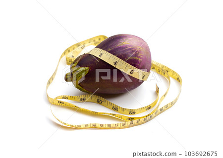 Measuring tape around eggplant on white background. Measuring tape around eggplant on white background. 103692675