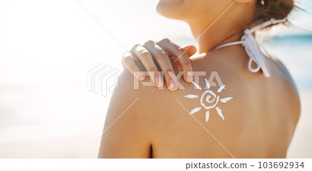 Protected against the sun. a young woman posing with suntan lotion on her shoulder. 103692934
