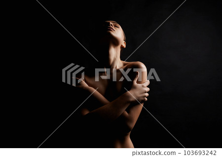Nude Woman silhouette in the dark. Beautiful Naked Body Girl Nude Woman silhouette in the dark. Beautiful Naked Body Girl 103693242