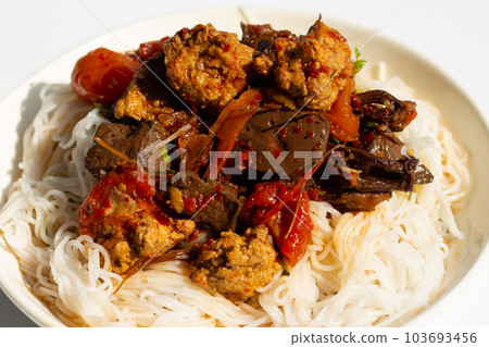 Rice noodles with Northern Thai pork curry in white plate on white background. 103693456