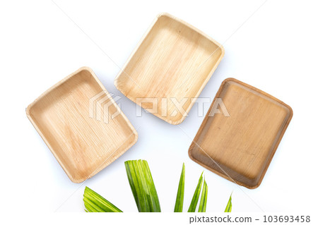 Betel palm leaf plates on white background. 103693458