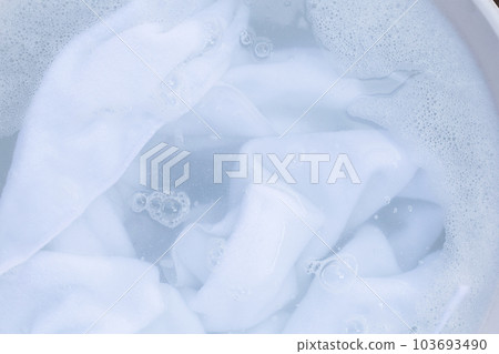 Top view of towel soak in powder detergent water dissolution. Laundry concept 103693490