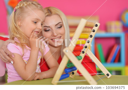 Little girl with mother using abacus 103694375