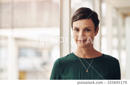 Business is booming. Cropped portrait of an attractive young businesswoman standing in her office. 103695179