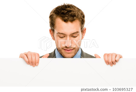 Finding the perfect space. Shot of a businessman holding a blank placard against a studio background. Finding the perfect space. Shot of a businessman holding a blank placard against a studio background. 103695327