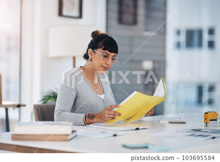 One last read through the files. an attractive young businesswoman sitting alone in her office and reading through paperwork. One last read through the files. an attractive young businesswoman sitting alone in her office and reading through paperwork. 103695584