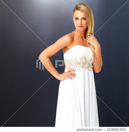 Beautiful, elegant and fashion with young woman wearing a white dress or evening gown for her wedding, prom or formal event with copy space. Classy and confident female dressed for a fancy party Beautiful, elegant and fashion with young woman wearing a white dress or evening gown for her wedding, prom or formal event with copy space. Classy and confident female dressed for a fancy party 103695591