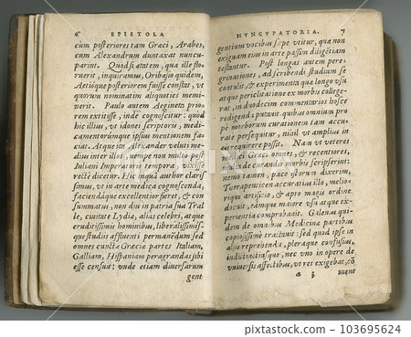 Weathered old journal in Latin. An antique book with its pages on display. Weathered old journal in Latin. An antique book with its pages on display. 103695624