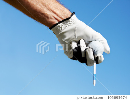 Golf ball, tee and hands of man on blue sky for contest, competition challenge and summer training on mockup. Closeup, gloves and golfer holding pin for action, games and outdoor gear for sports Golf ball, tee and hands of man on blue sky for contest, competition challenge and summer training on mockup. Closeup, gloves and golfer holding pin for action, games and outdoor gear for sports 103695674