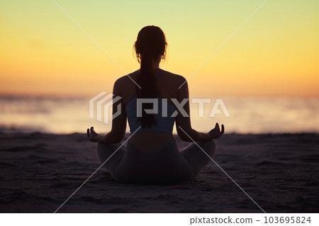 Bonding with the universe. a unrecognizable female doing yoga at the beach. Bonding with the universe. a unrecognizable female doing yoga at the beach. 103695824