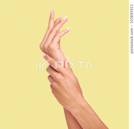Skincare, yellow background and hands of woman in studio for wellness, cosmetics and manicure treatment. Spa aesthetic, beauty salon and isolated palms of girl apply lotion, nail cream or moisturizer Skincare, yellow background and hands of woman in studio for wellness, cosmetics and manicure treatment. Spa aesthetic, beauty salon and isolated palms of girl apply lotion, nail cream or moisturizer 103695911