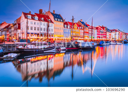 Copenhagen, Denmark. Nyhavn, Kobenhavn's iconic canal, colorful night water reflection. Copenhagen, Denmark. Nyhavn, Kobenhavn's iconic canal, colorful night water reflection. 103696290
