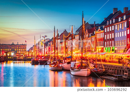 Copenhagen, Denmark. Nyhavn, Kobenhavn's iconic canal, colorful evening water reflection. Copenhagen, Denmark. Nyhavn, Kobenhavn's iconic canal, colorful evening water reflection. 103696292