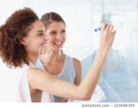 Happy business woman, coaching and writing for planning, presentation or schedule at the office. Female coach or mentor with smile for project plan, tasks or training staff on whiteboard at workplace 103696394