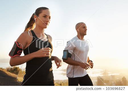 Wellness, fitness or people running and listening to music in morning workout or exercise for wellness. Sport, man and woman runner with athlete as training for marathon run, sports or energy radio Wellness, fitness or people running and listening to music in morning workout or exercise for wellness. Sport, man and woman runner with athlete as training for marathon run, sports or energy radio 103696827