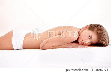 Sexy, underwear and portrait of woman in bed with confidence, seductive and sensual pose at home. Morning, lingerie and beautiful, gorgeous and attractive female person laying on white background 103696971