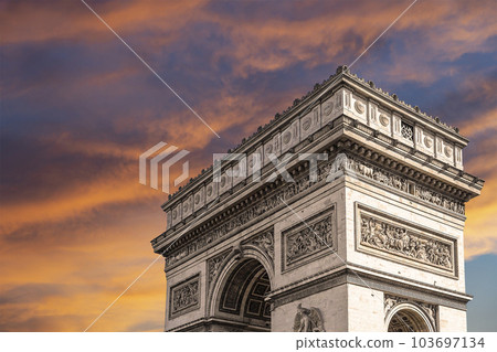 Arc de Triomphe (against the background of sky with clouds), Paris, France. The walls of the arch are engraved with the names of 128 battles and names of 660 French military leaders (in French) 103697134
