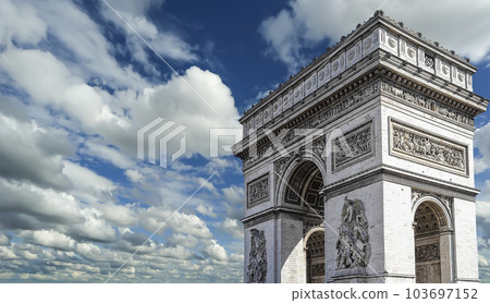Arc de Triomphe (against the background of sky with clouds), Paris, France. The walls of the arch are engraved with the names of 128 battles and names of 660 French military leaders (in French) 103697152
