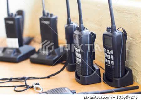 Charge, radio and walkie talkie for communication, equipment and battery with connection. Technology, tools and receiver with transmitter, portable and security with protection, energy and network Charge, radio and walkie talkie for communication, equipment and battery with connection. Technology, tools and receiver with transmitter, portable and security with protection, energy and network 103697273