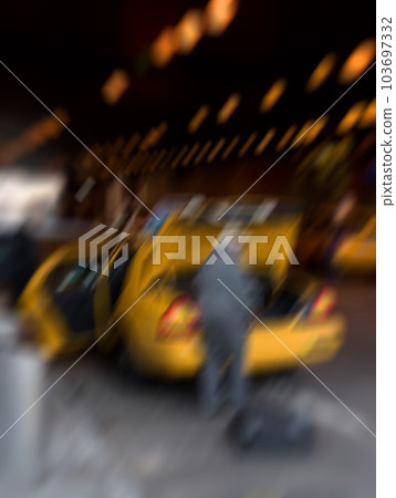 Manhattan - blurred taxi. Lens blurred photo Everyday street life in New York - Manhattan. Manhattan - blurred taxi. Lens blurred photo Everyday street life in New York - Manhattan. 103697332