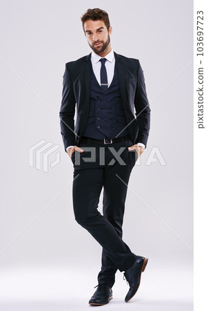 Portrait, suit and man with fashion, confidence and happiness isolated against a studio background. Face, male person and ceo with business mindset, success and pride with stylish clothes and outfit 103697723