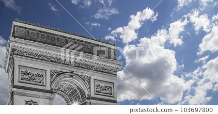 Arc de Triomphe (against the background of sky with clouds), Paris, France. The walls of the arch are engraved with the names of 128 battles and names of 660 French military leaders (in French) Arc de Triomphe (against the background of sky with clouds), Paris, France. The walls of the arch are engraved with the names of 128 battles and names of 660 French military leaders (in French) 103697800
