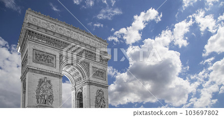 Arc de Triomphe (against the background of sky with clouds), Paris, France. The walls of the arch are engraved with the names of 128 battles and names of 660 French military leaders (in French) Arc de Triomphe (against the background of sky with clouds), Paris, France. The walls of the arch are engraved with the names of 128 battles and names of 660 French military leaders (in French) 103697802