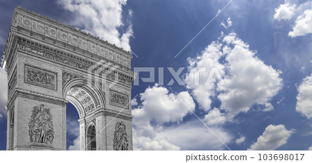 Arc de Triomphe (against the background of sky with clouds), Paris, France. The walls of the arch are engraved with the names of 128 battles and names of 660 French military leaders (in French) 103698017