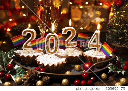Food tray with cupcakes new year candles wineglasses and rainbow flags decorations Food tray with cupcakes new year candles wineglasses and rainbow flags decorations 103699475