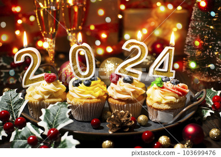 Food tray with cupcakes new year candles and wineglasses Food tray with cupcakes new year candles and wineglasses 103699476