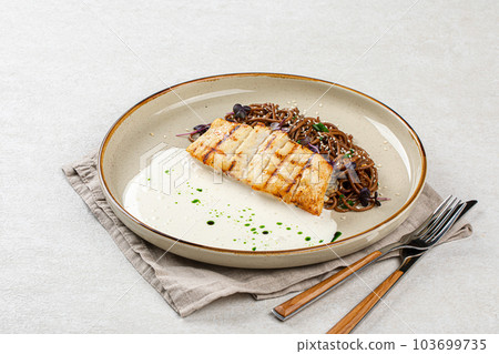 Halibut fillet with soba noodles and creamy sauce 103699735