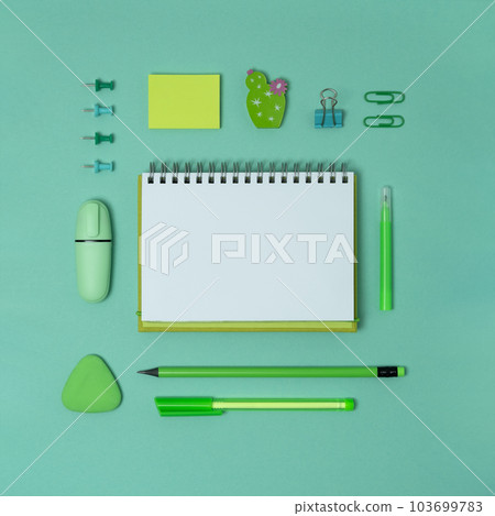 Open notebook with space for your text with green school and office supplies Open notebook with space for your text with green school and office supplies 103699783