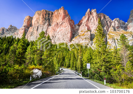 Dolomites, Italy. Sella Ronda mountain ridge and winding road to Sella Pass 103700176