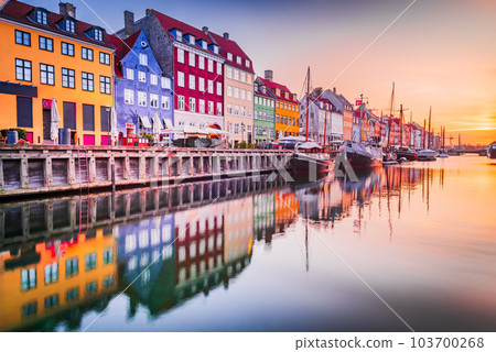 Copenhagen, Denmark. Nyhavn, Kobenhavn's iconic canal, colorful sunrise water reflection. Copenhagen, Denmark. Nyhavn, Kobenhavn's iconic canal, colorful sunrise water reflection. 103700268