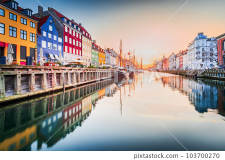 Copenhagen, Denmark. Nyhavn, Kobenhavn's iconic canal, colorful sunrise water reflection. Copenhagen, Denmark. Nyhavn, Kobenhavn's iconic canal, colorful sunrise water reflection. 103700270