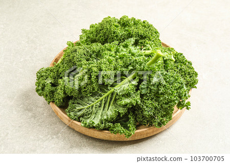Fresh kale leaves on light grey table Fresh kale leaves on light grey table 103700705