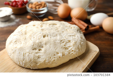 Board with wheat dough for pastries, closeup 103701384