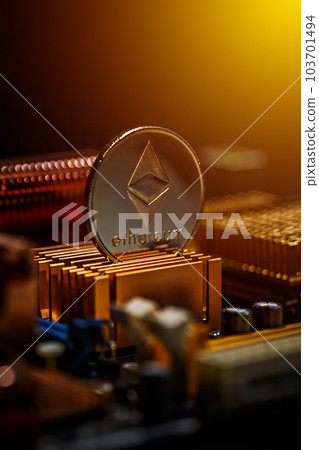 Ethereum coin on a computer motherboard 103701494