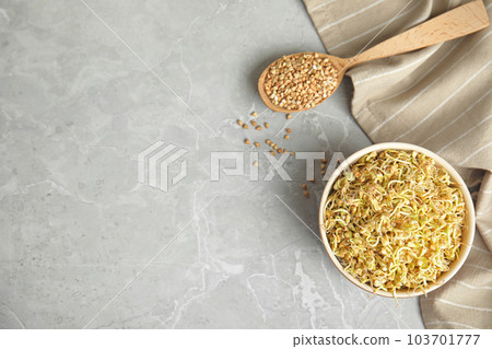 Flat lay composition with green buckwheat on light grey table, space for text 103701777