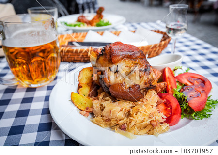 Bavarian traditional food plate, pork hock baked with beer, Schweinshaxe. 103701957