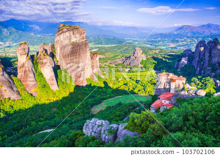 Meteora, Greece. Incredible sunrise view of sandstone rock formations and monasteries. 103702106