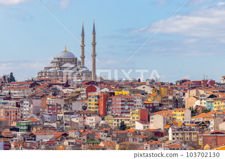 Suleymaniye mosque with colorful residential house area in Istanbul with blue sky background, Turkey, Istanbul Mosque Suleymaniye minaret with colorful house, Beautiful view Istanbul, Turkiye. 103702130