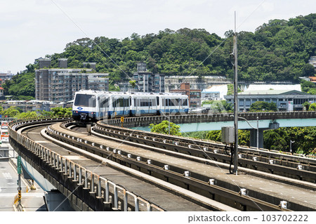 Wenhu or Brown line of Taipei MRT in Taiwan. View of a train running on the elevated track of the Taipei subway system under a clear blue sky. Wenhu or Brown line of Taipei MRT in Taiwan. View of a train running on the elevated track of the Taipei subway system under a clear blue sky. 103702222