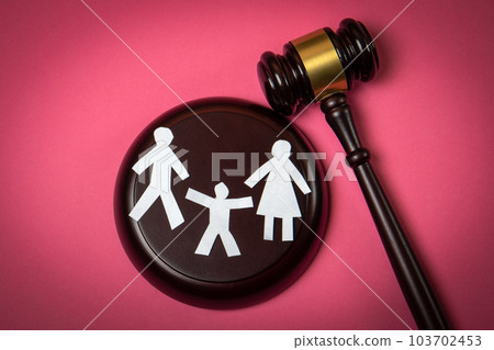 Domestic violence concept. Paper people and gavel on pink background Domestic violence concept. Paper people and gavel on pink background 103702453