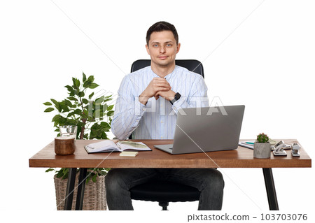 young man using laptop computer for online work at table 103703076