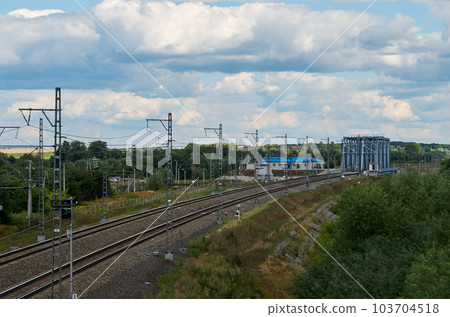Railroad bend in front of a small steel bridge 103704518
