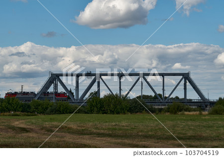 The train goes over a small railway bridge The train goes over a small railway bridge 103704519