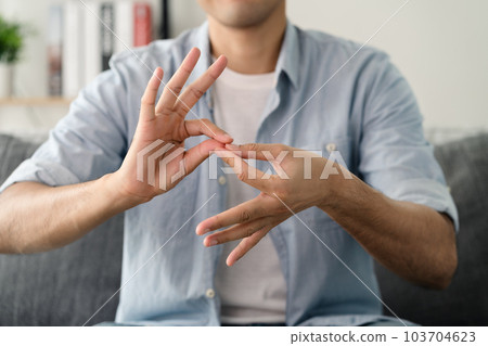 Happy young deaf man using sign Language to communicate with other people.. Happy young deaf man using sign Language to communicate with other people.. 103704623